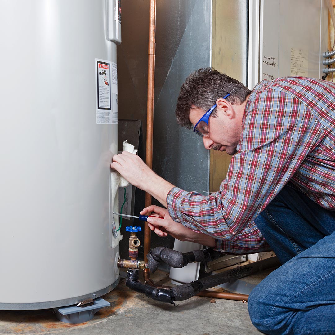 Repairman working on a water heater
