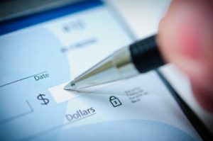 Discover How to Deal with Late Rent Payments from Atlanta Tenants atlanta tenant writing check