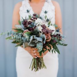 A stunning bride and her bouquet by Fort Collins best wedding florist.