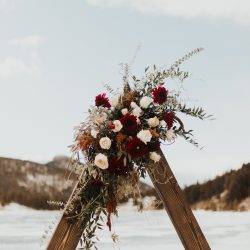 Stunning wood triangle arch from Bliss Wedding Florist.