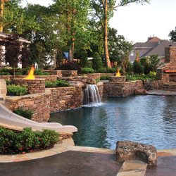 Pool with beautiful hardscape and slide.