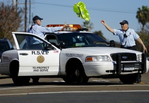 88-year-old Ed Robles (R) throws a safety vest to partner Dick Engel after directing traffic at the scene of a car accident, February 4, 2015. Photo by Mike Blake/Reuters