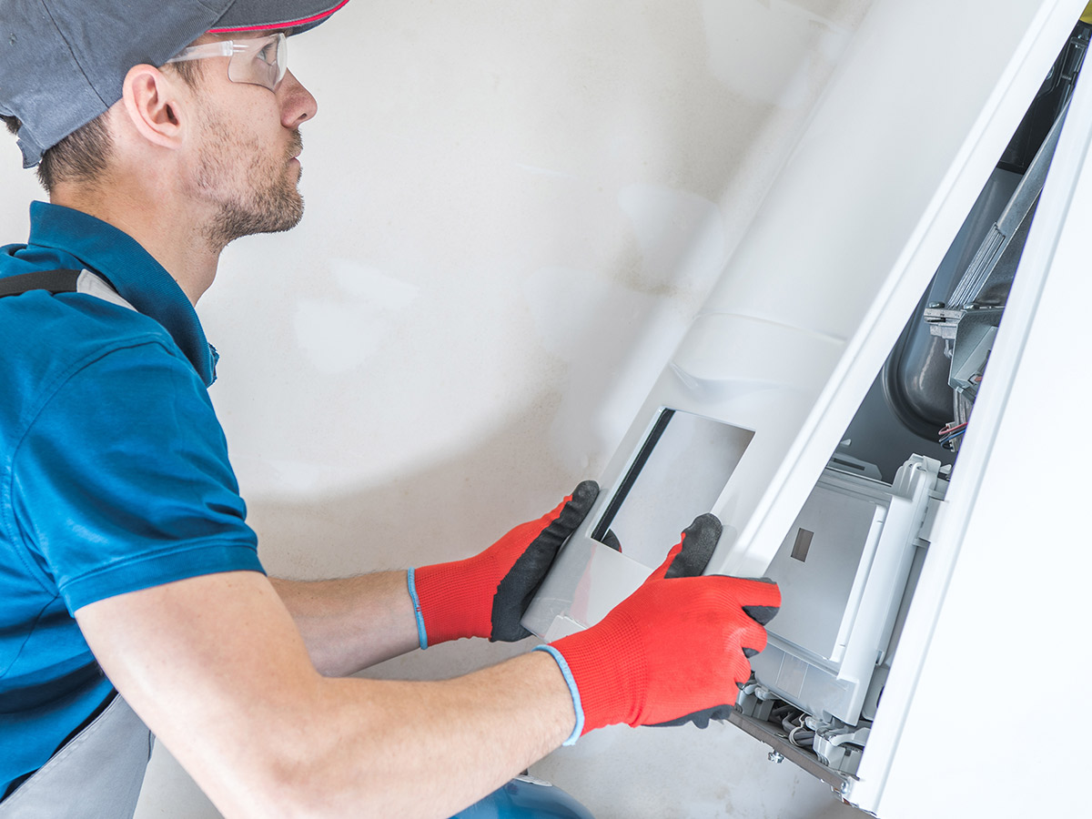Technician providing maintenance to HVAC system