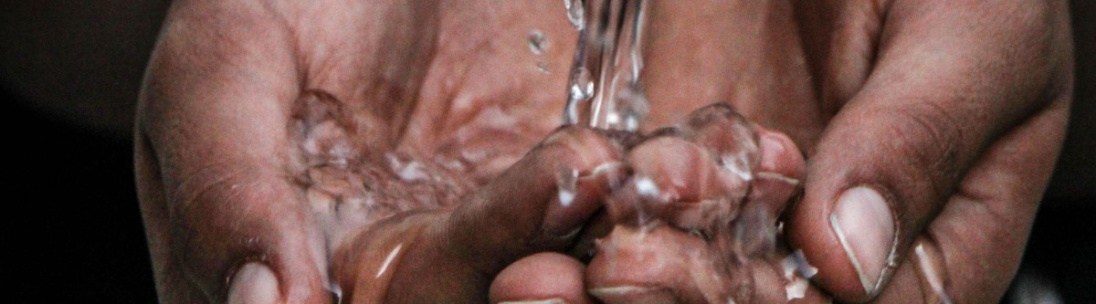 water flowing into cupped hands