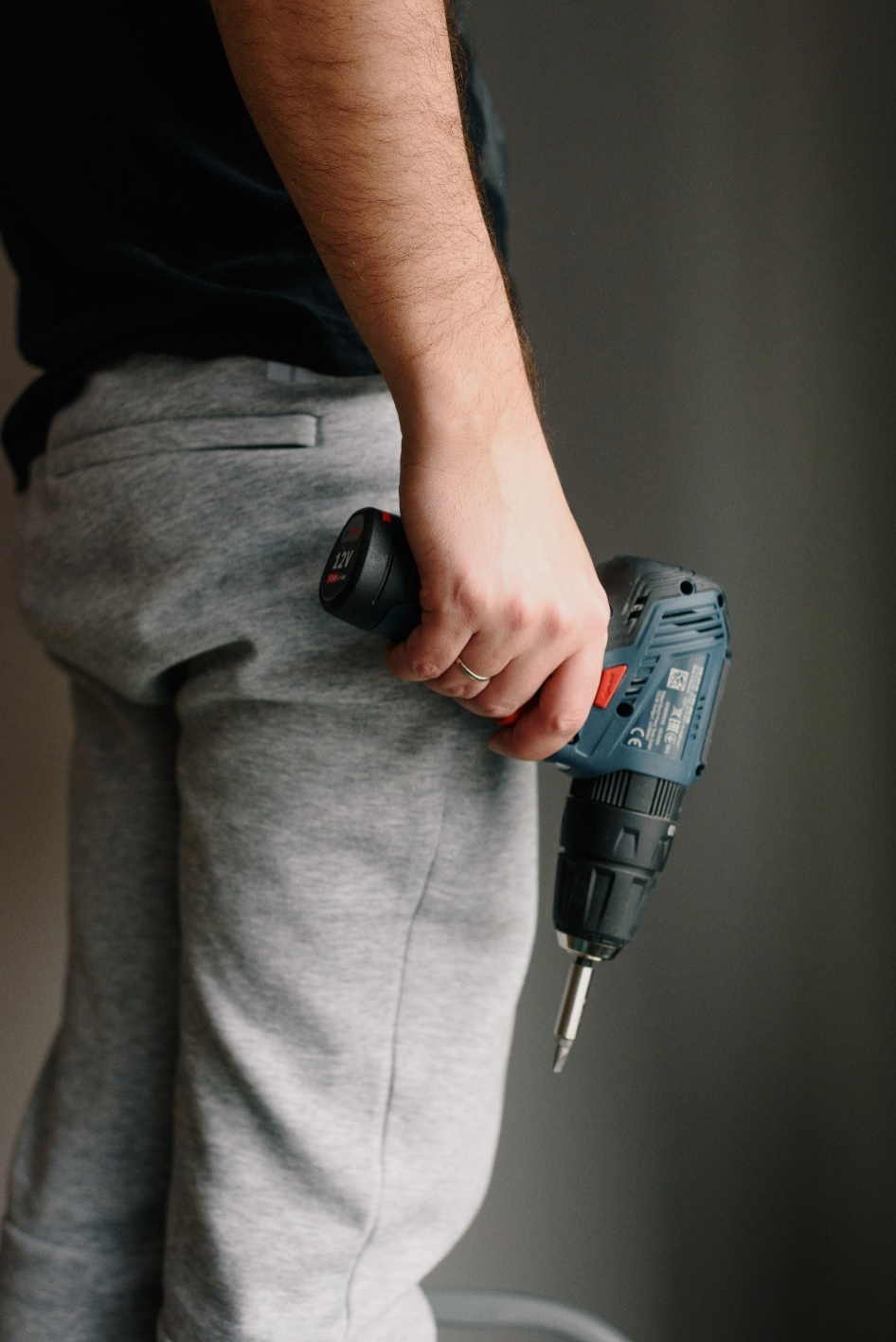 A repairman holding a drill.