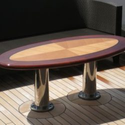 An image of a custom wooden outdoor table made by Dennis Boatworks.