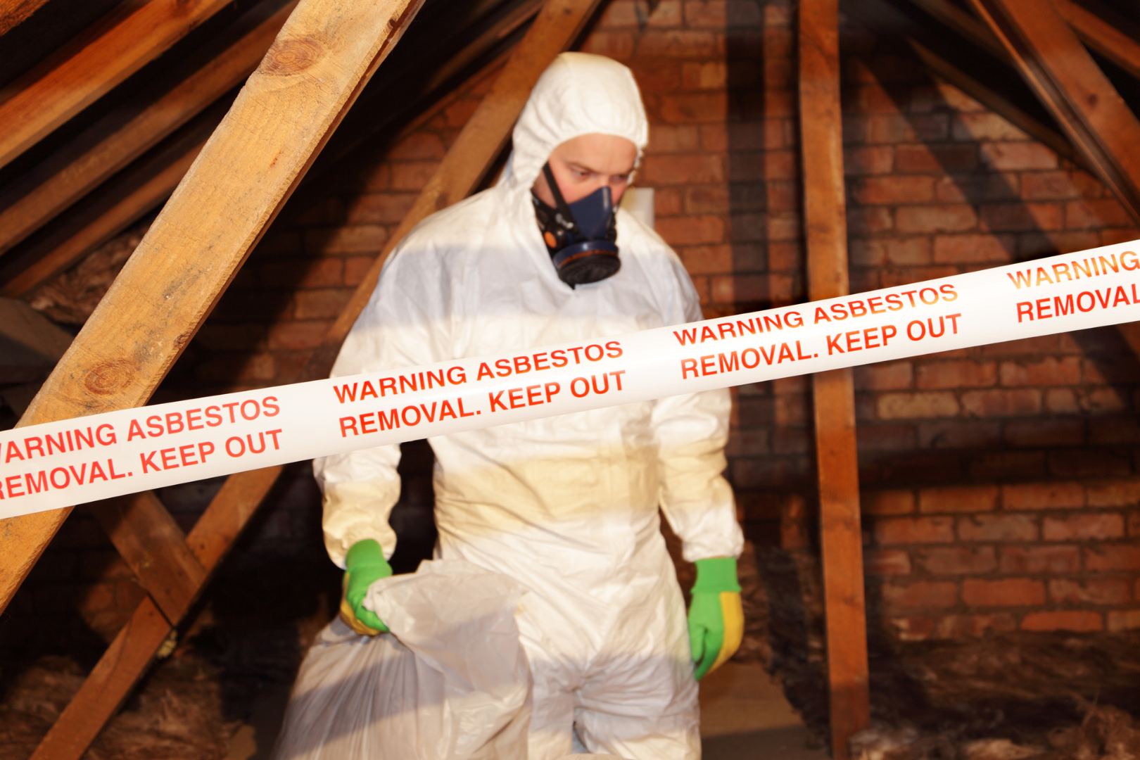 asbestos in a garage with a demolition worker