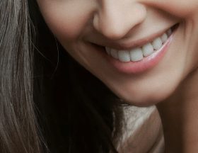 A close-up of a smiling woman. Photo by Alexander Krivistskiy on Unsplash.