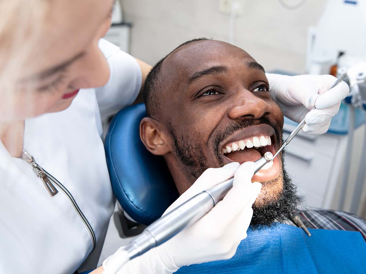 young man getting his teeth cleaned
