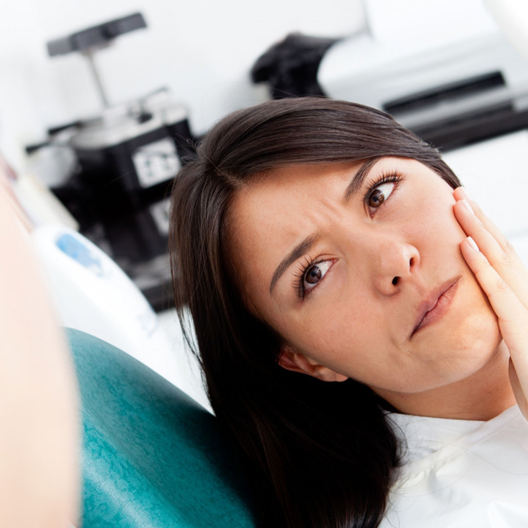 Women at the dentist complaining about a tooth pain