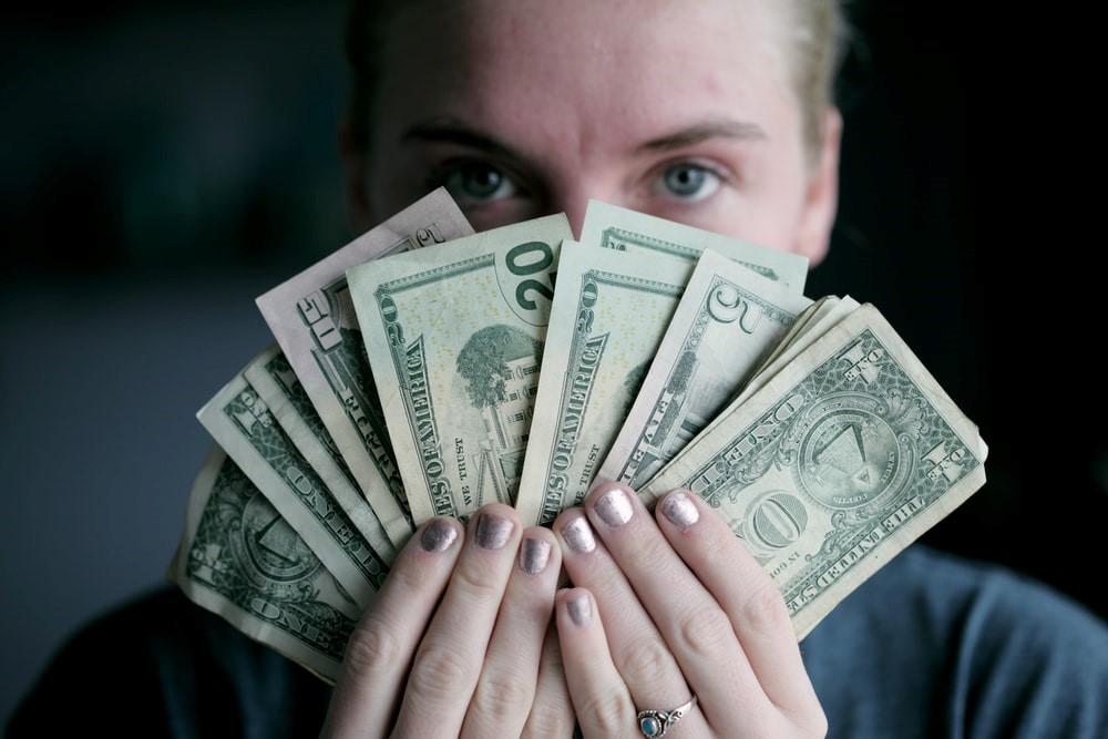 A woman holding money 