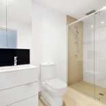 sink, toilet, shower in white bathroom