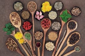 Spices and Health Foods in Bowls and Wooden Spoons