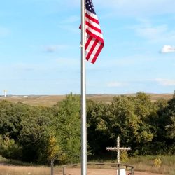 A flag pole being installed in a cemetery - ND Flag Pole Guy