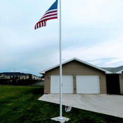 Flag pole installed in a yard - ND Flag Pole Guy