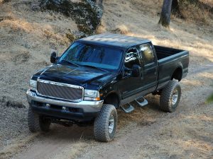 Lifted truck driving on a dirt road