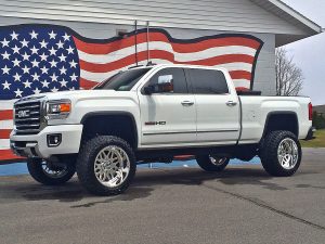 Lifted truck parked in front of a garage