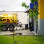 Yellow fuel delivery truck providing on-site fueling
