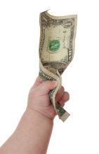 baby holding a dollar