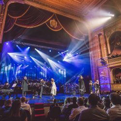 Singers and musicians performing classical and classic rock during a Rocktopia live performance.