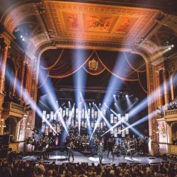 Rocktopia perfoming live on stage at an opera house.