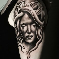 Black and grey realism tattoo of Medusa and snakes. Light shading on the left shoulder.