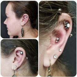 Industrial piercing with a 14 gauge internally threaded bar and an opal adornment