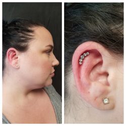 Outer conch piercing with a 16 gauge internally threaded 5 stone crescent cluster in clear CZ.
