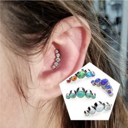 Inner conch piercing with a 16 Gauge internally threaded 5 stone crescent cluster in CZ.