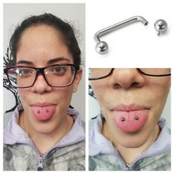 Venom piercing with an internally threaded 14 gauge surface bar.