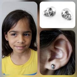 Ear piercings with 18 gauge internally threaded, stainless steel skull tops.