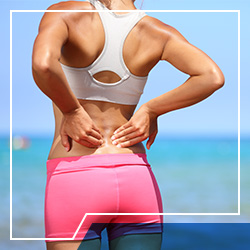woman holding back due to spinal disc pain