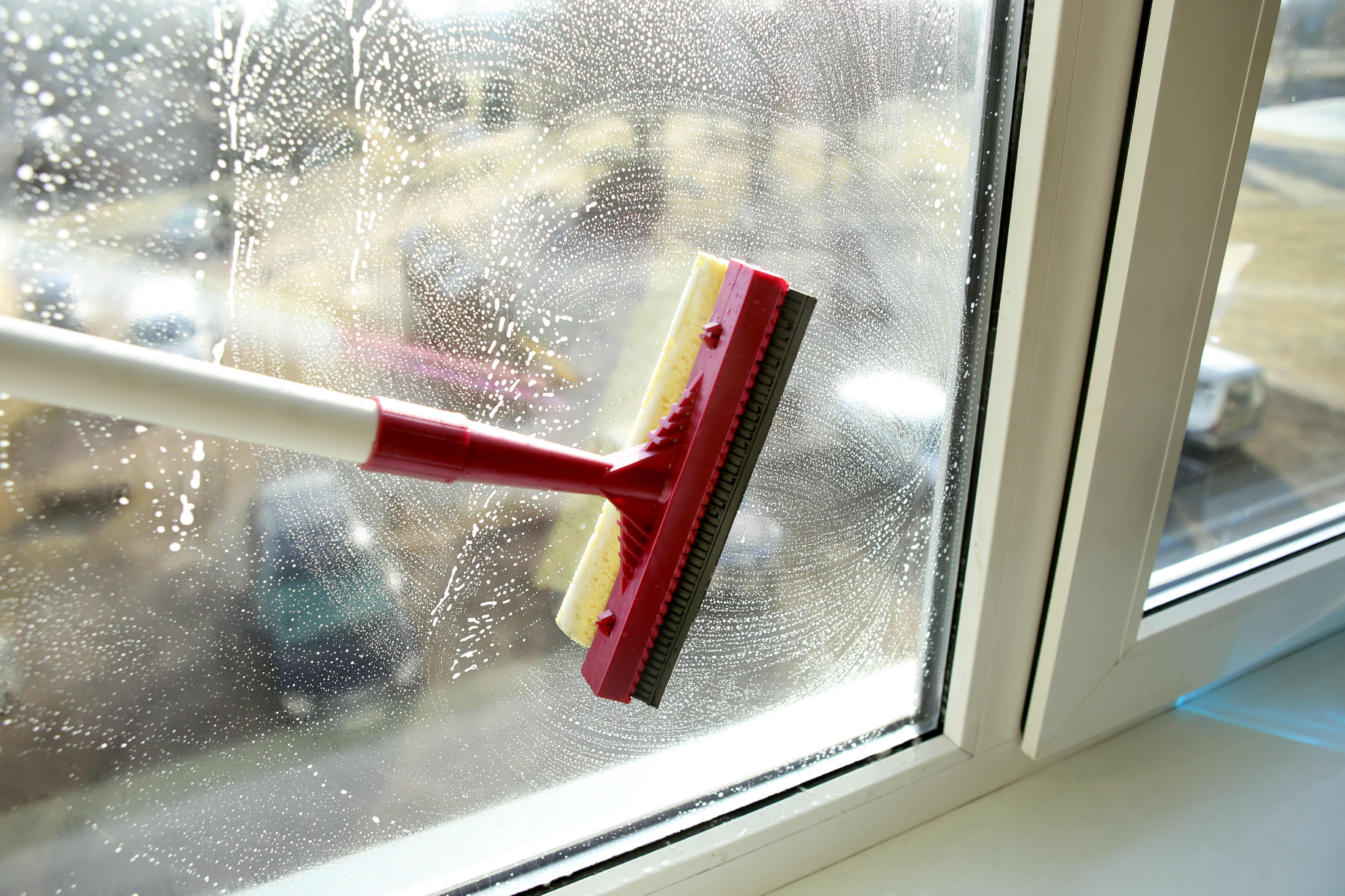 interior window being washed with squeegee