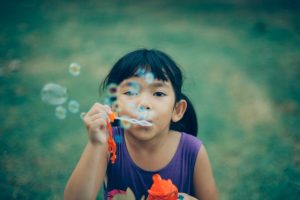 girl blowing bubbles